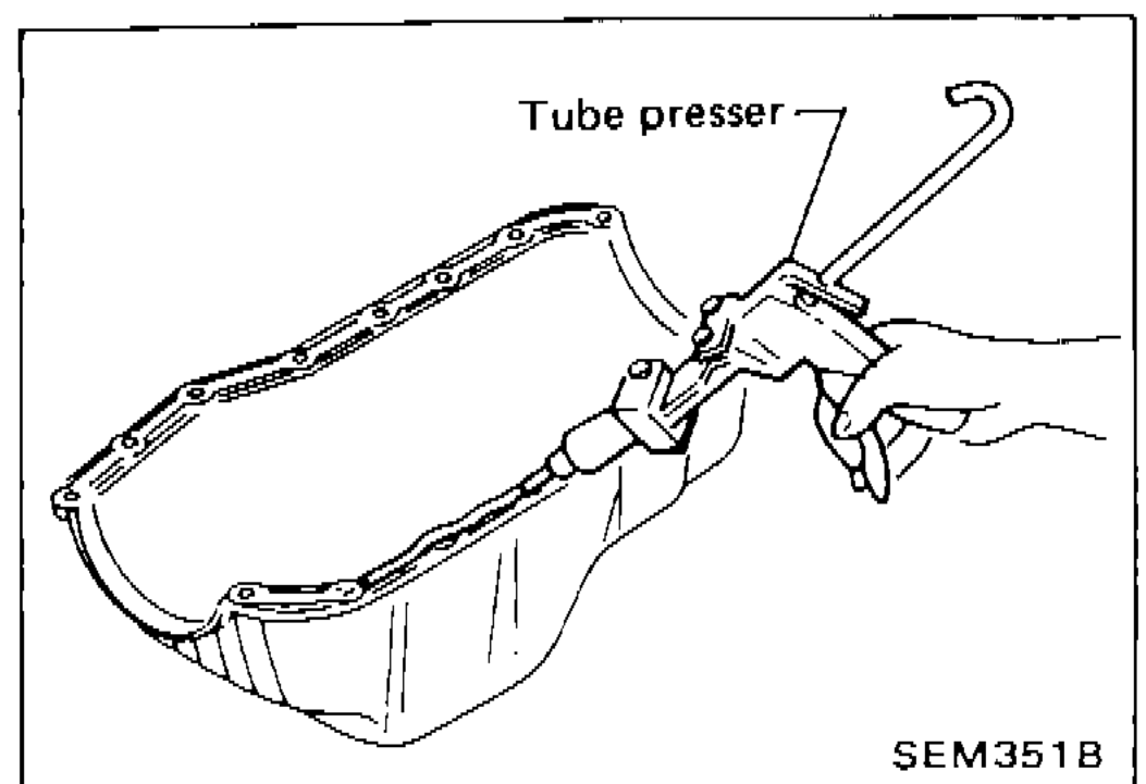 Hand using a tube presser to apply liquid gasket to the mating surface of the oil pan
