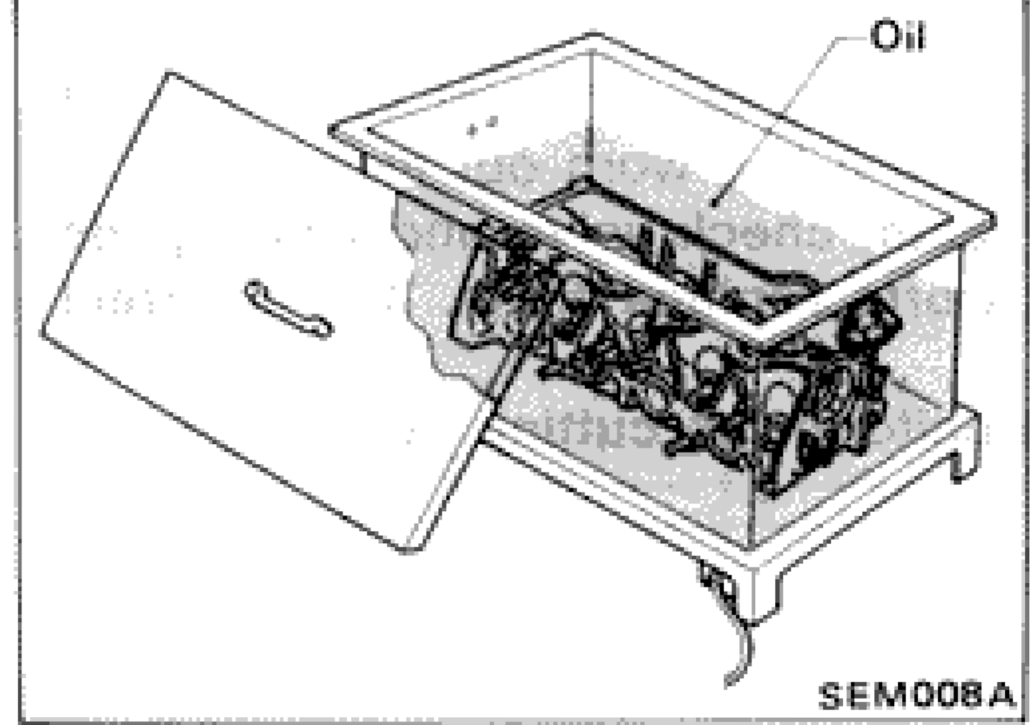 Cylinder head submerged in oil bath for heating during valve guide removal
