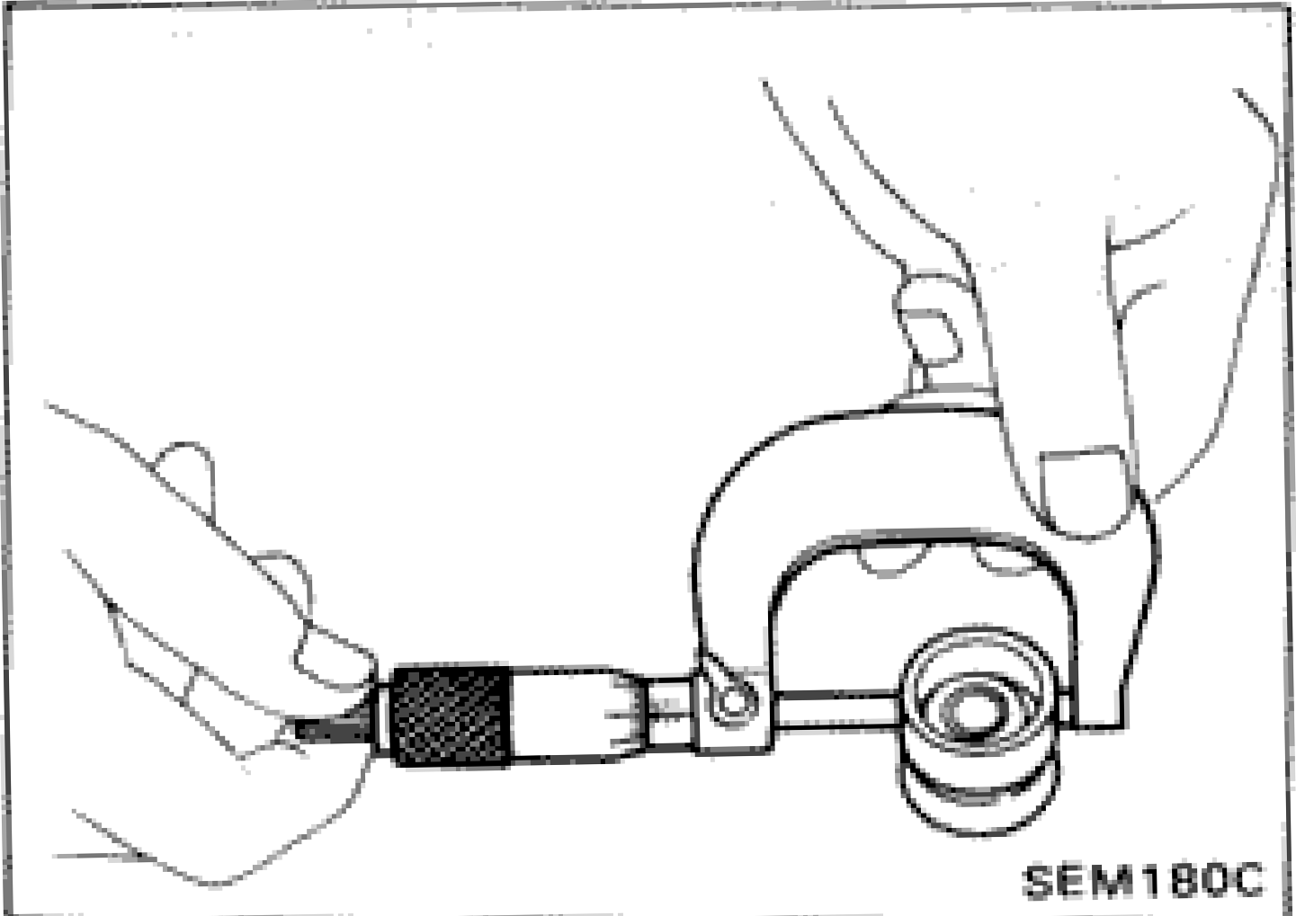 Micrometer being used to measure outer diameter of valve lifter