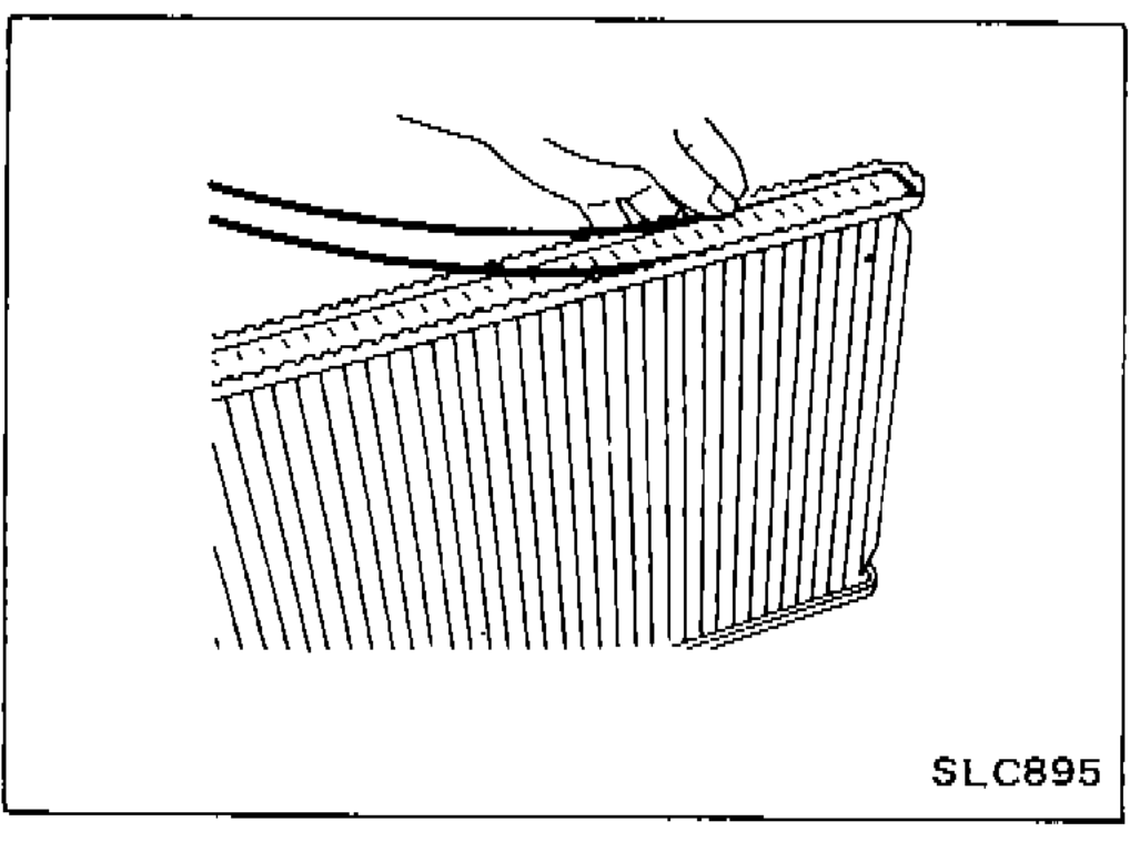 Hands pushing sealing rubber into the radiator tank with fingers