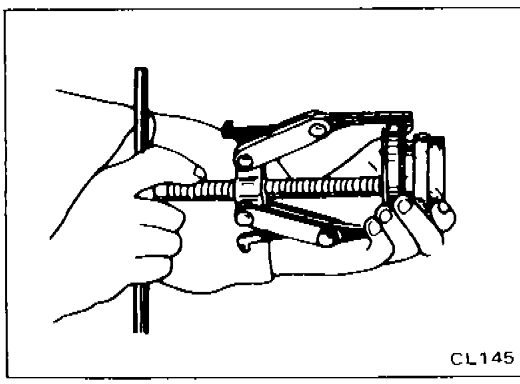 Photo showing hands removing the release bearing from the withdrawal lever assembly.
