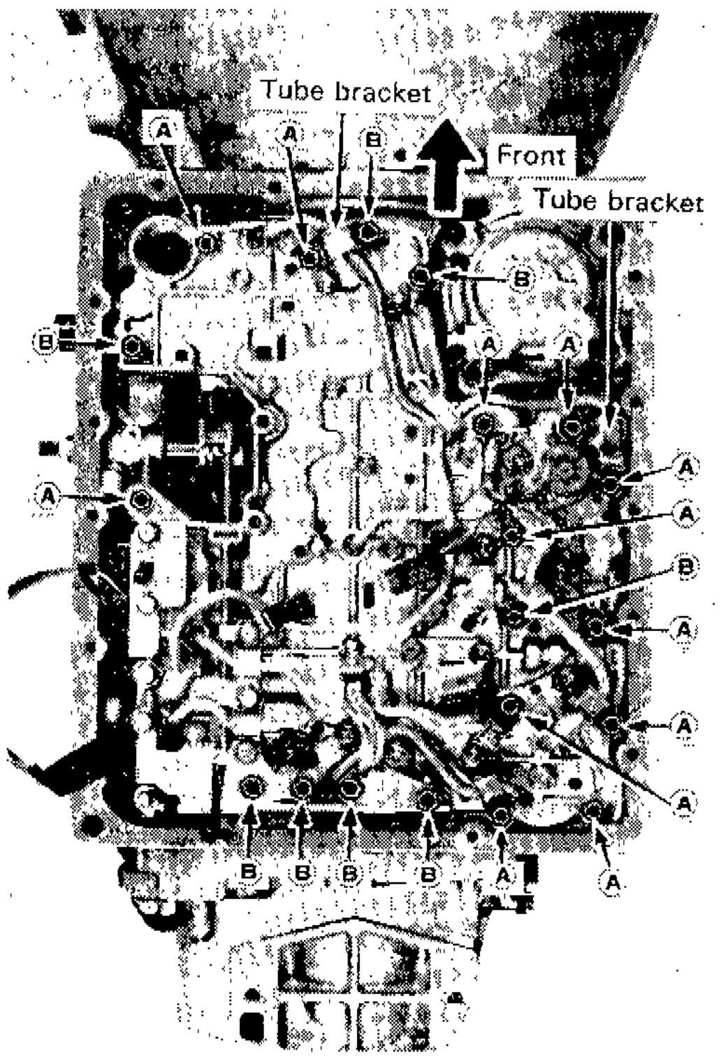 Control valve assembly viewed from below showing bolt symbol locations A and B, and tube bracket positions, with Front direction arrow