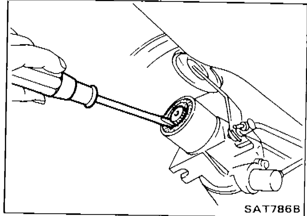 Illustration showing removal of rear oil seal using a tool