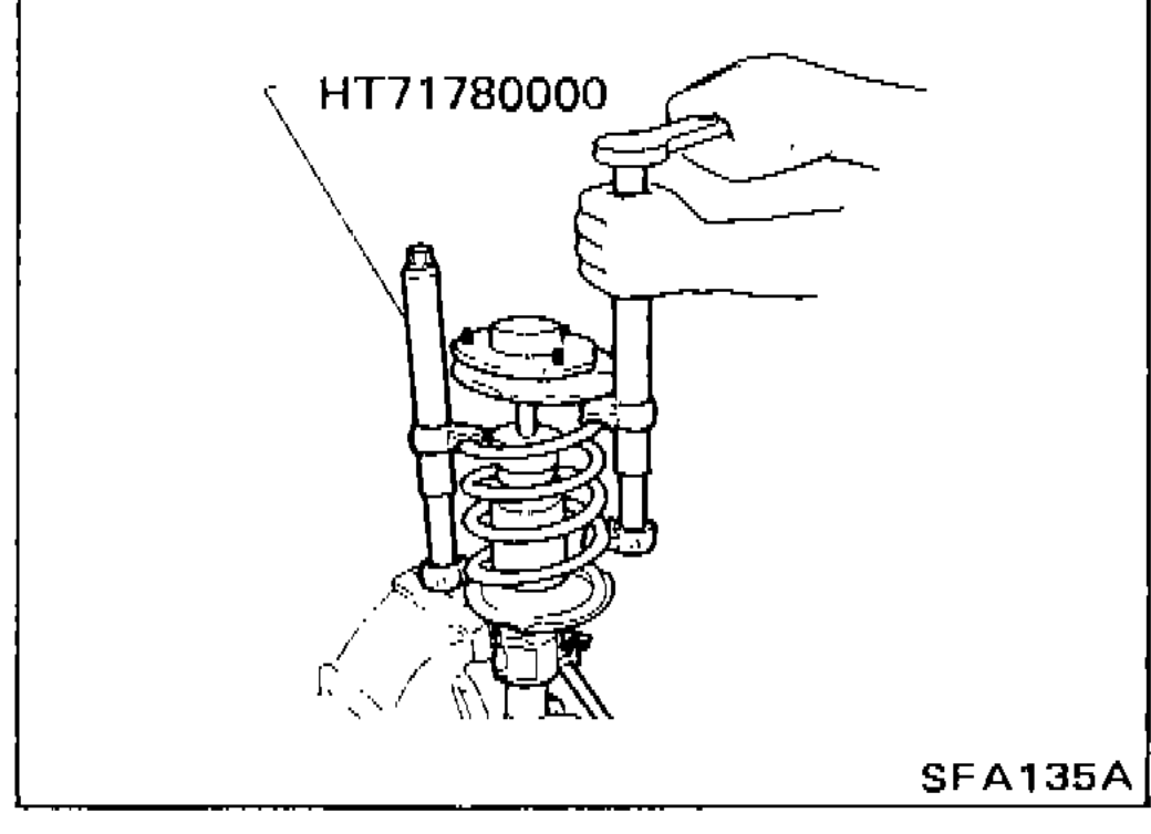 Tool HT71780000 compressing spring so strut mounting insulator can be turned by hand
