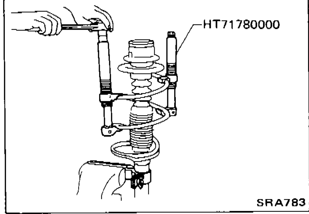 Strut assembly clamped in a vise using attachment ST35652000; piston rod lock nut being loosened from above with a wrench.