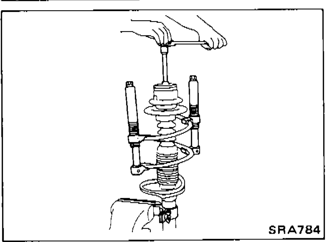 Spring compressor (Tool HT71780000) compressing the strut coil so the upper spring seat can be turned by hand.
