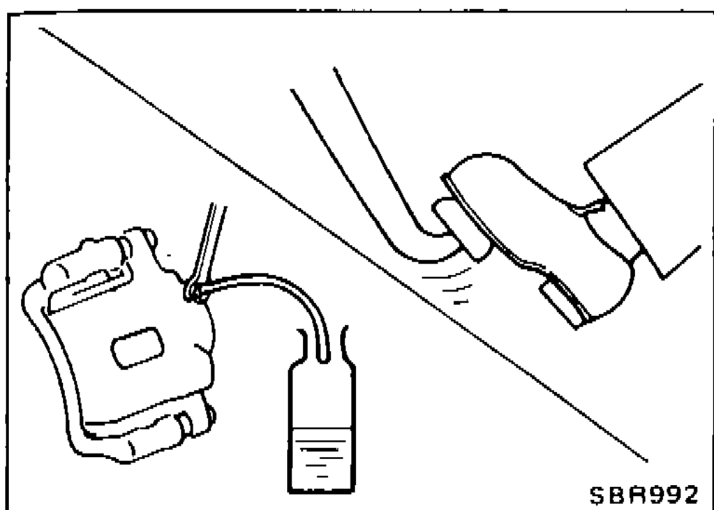Caliper bleeder valve with clear vinyl tube draining to a catch container — used for the bleed-air procedure.
