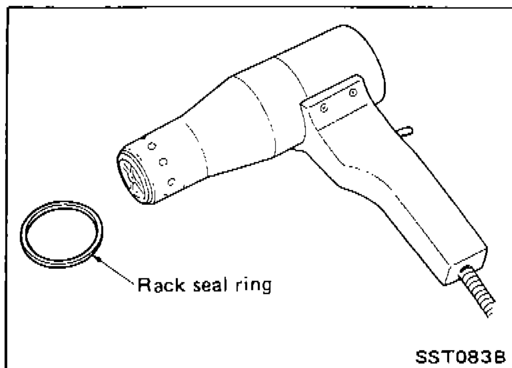 Heat gun warming a teflon rack-seal ring before installation onto the rack.